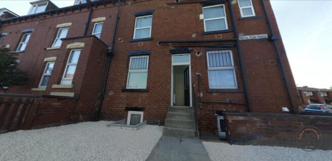 Red-brick terraced property with gravelled fron...