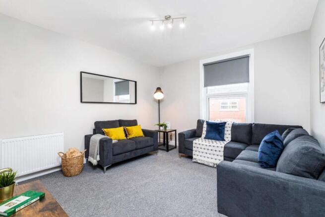 Bright, modern living room with two comfortable...