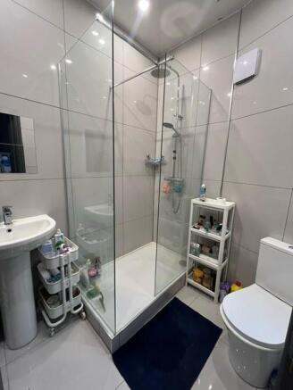 Modern bathroom with large corner glass shower ...