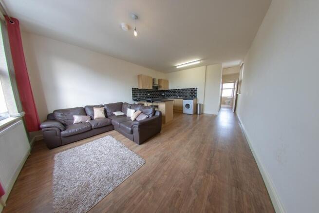 Spacious open-plan living area with a large L-s...