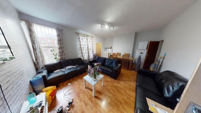 Bright, well-furnished living room with large w...