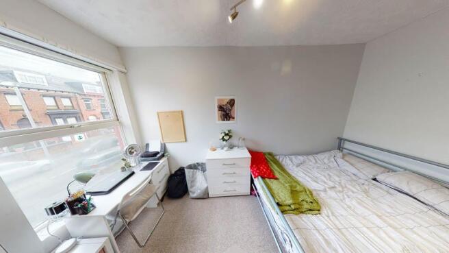 Bright, simply furnished double bedroom with a ...