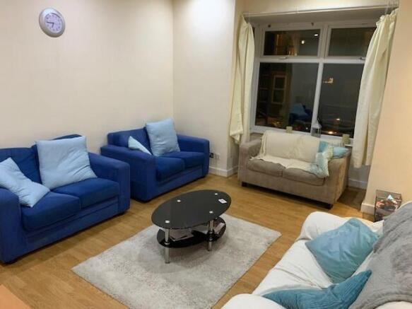 Bright, neatly furnished living room with comfy...
