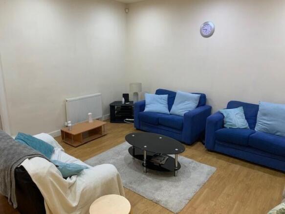 Bright, neatly presented living room with match...