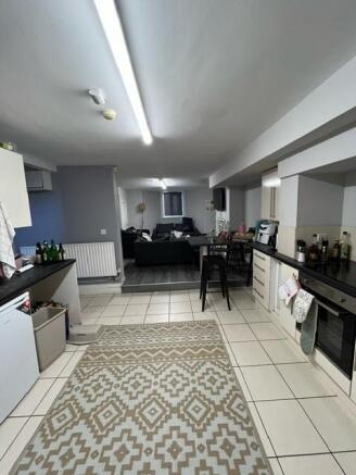 Open-plan lower-ground living space with a fitt...