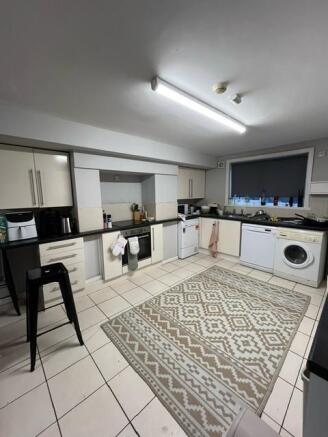 Bright, modern kitchen with plenty of cupboard ...