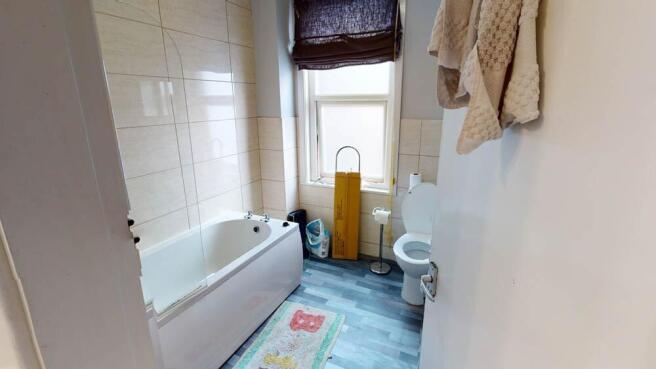 Bright, well-kept bathroom with a full bathtub,...