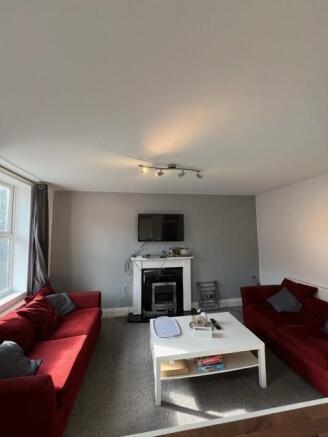 Bright, comfortable living room with two matchi...