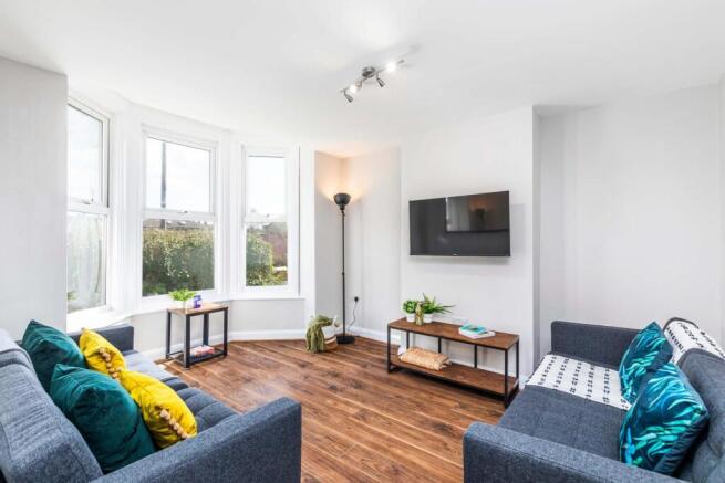 Bright, modern living room with large bay windo...