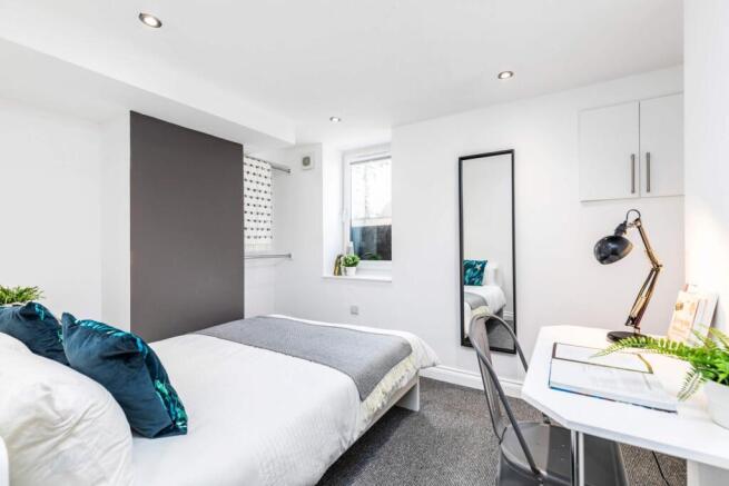 Bright, modern double bedroom with a comfortabl...