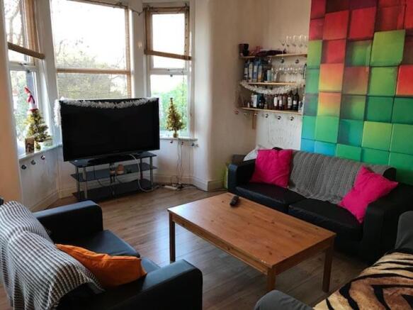 Bright, contemporary living room with a bay win...