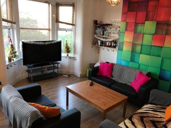 Bright, comfortable living room with bay window...