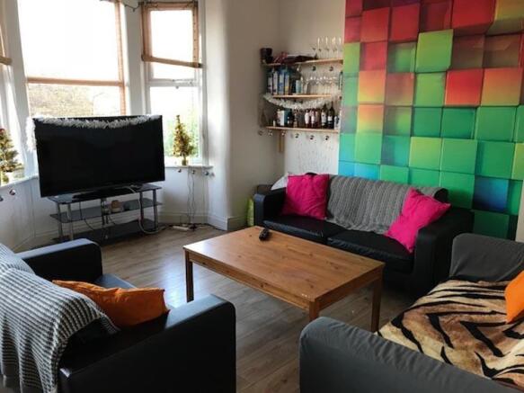 Bright, modern living room with colourful featu...