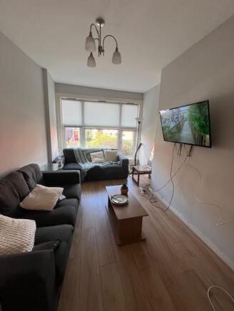 Bright, modern living room with two sofas, wall...