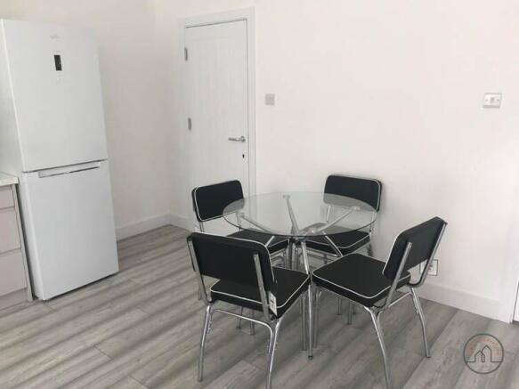 Bright kitchenette area with modern laminate fl...