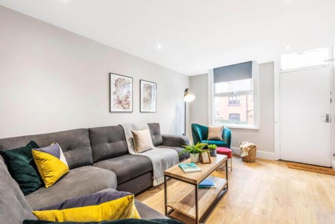 Bright, modern living room with a comfortable g...