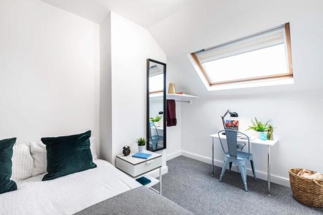 Bright, neatly styled bedroom with a double bed...