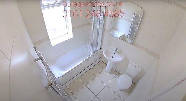 Bright, modern bathroom with a fitted bath and ...