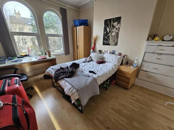 Bright double bedroom with large arched windows...