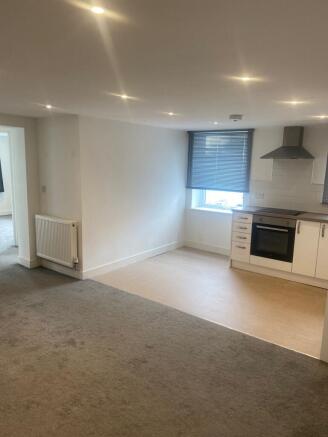 Bright open-plan living area with a fitted kitc...