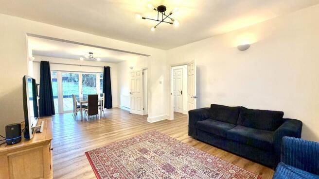 Bright, modern living room with wood-effect flo...