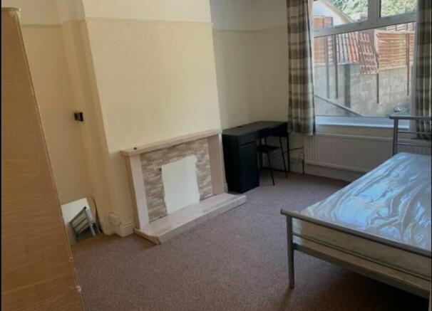 A spacious and well-lit double bedroom featurin...