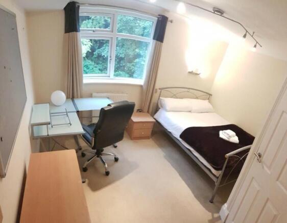 A bright and tidy double bedroom featuring a co...