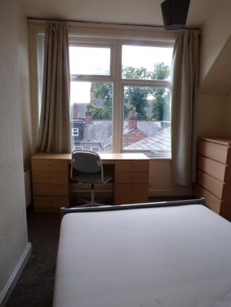 A bright and inviting double bedroom with ample...