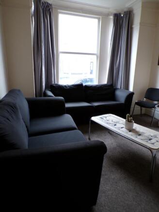 A spacious and well-lit large modern living roo...