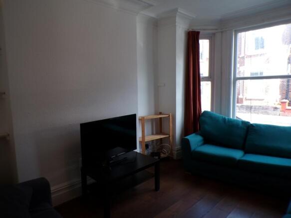 A bright and inviting living room featuring a c...