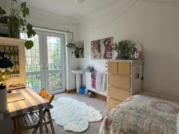 A bright and inviting double bedroom featuring ...
