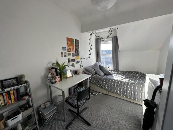 A bright and inviting double bedroom featuring ...