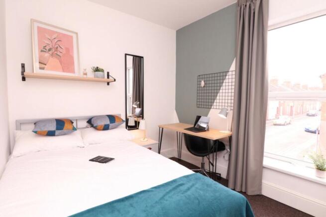 A stylish and inviting double bedroom with ampl...
