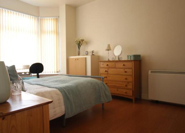 A bright and inviting double bedroom with ample...