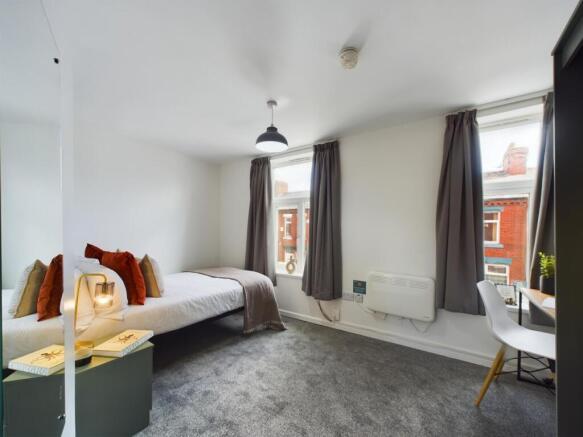 A bright and inviting double bedroom featuring ...