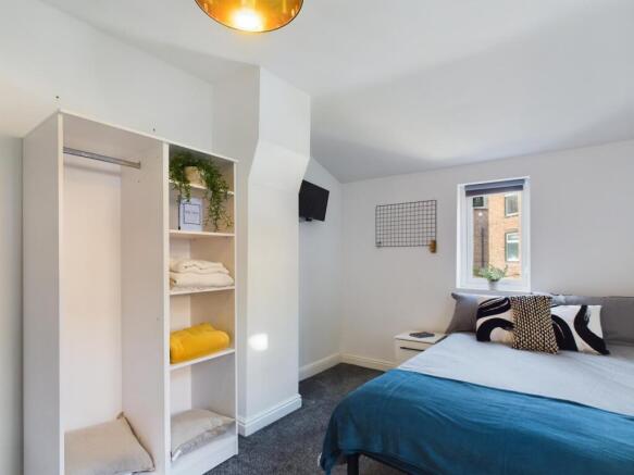 A bright and inviting double bedroom featuring ...