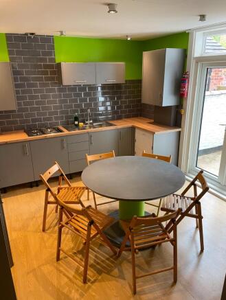 Modern kitchen featuring sleek cabinetry and a ...