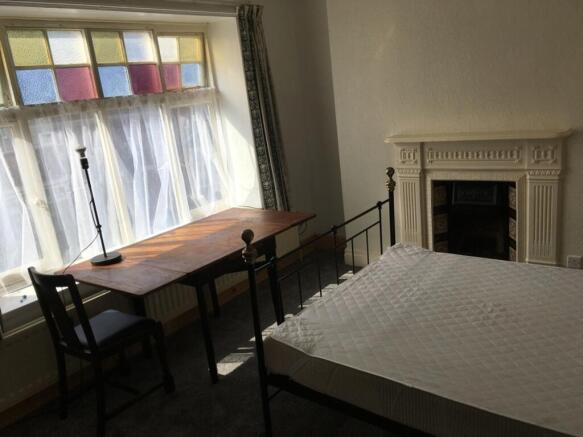 This charming double bedroom features ample nat...
