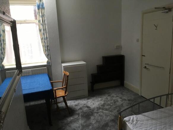This inviting double bedroom features a cozy at...