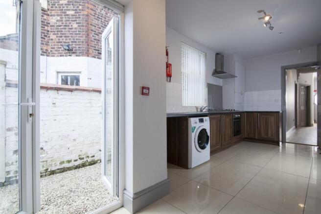 A modern and spacious kitchen area with ample n...