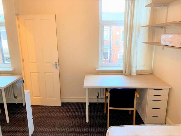 This spacious double bedroom features ample nat...