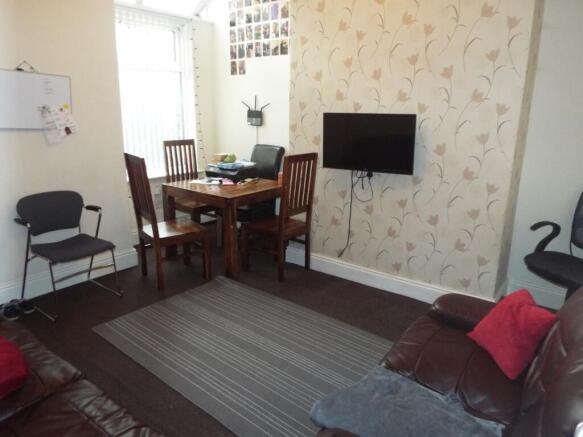A cozy living room featuring a comfortable seat...