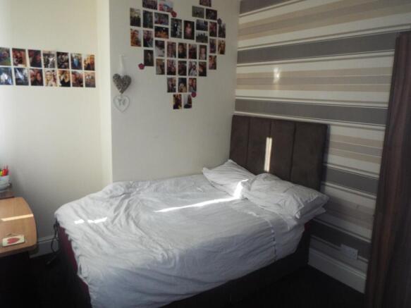 This inviting double bedroom features a cozy be...