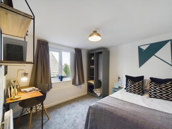 A modern and inviting double bedroom with ample...