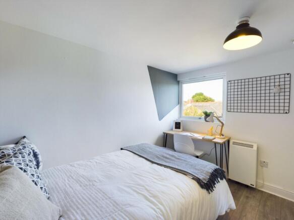 A bright and inviting double bedroom featuring ...