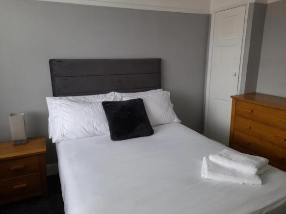 A beautifully arranged double bedroom featuring...