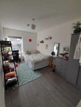 A cozy double bedroom featuring a comfortable b...