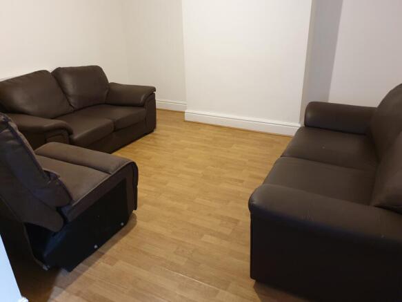 A cozy living room featuring comfortable brown ...