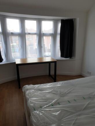 Bright and inviting double bedroom featuring la...