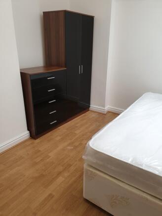 A bright and spacious double bedroom featuring ...